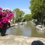 View of the canal from one of its quaint stone bridges - the French do love their flowers!