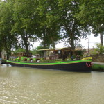 Tamata, the floating grocery store, is moored along the bank of the canal in Le Somail.