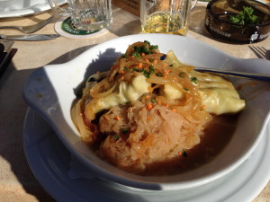 A local Schwabische regional specialty Maultaschen, a large ravioli filled with pork and spinach in either a clear broth, on sauerkraut, or on grilled onions.