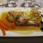 Braised leg of rabbit with scallop potatoes and carrots in a rabbit reduction.